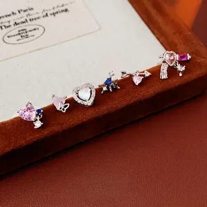 Silver heart and butterfly stud earring set with zircons on a brown velvet display