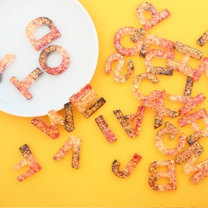 Golden sequin resin alphabet keychain set for DIY gifts with orange glitter finish