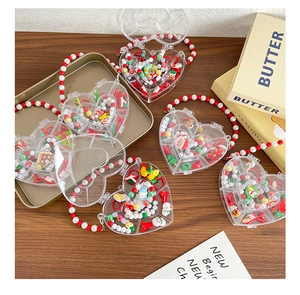 Detail of heart-shaped Christmas jewelry box with Santa charms and beaded handle