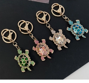 Detailed grid of crystal turtle keychains in green, pink, white, and blue colors