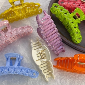 Close-up of assorted candy-colored large hair claws in vibrant translucent plastic
