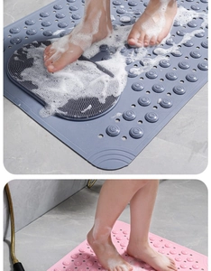 Detailed view of gray and pink non-slip bathroom mats with suction cups and drainage holes
