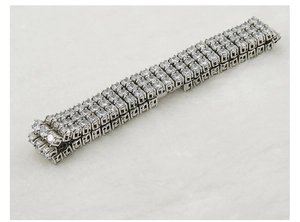 Detail view of silver steel bracelet featuring four-row pave-set clear zircon stones