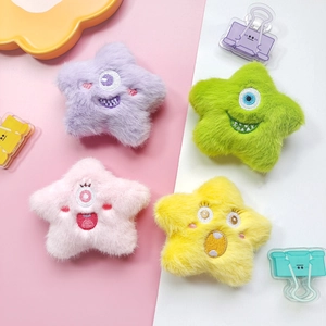 Detailed view of colorful plush star monster doll charms with exquisite embroidery