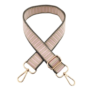 Detail of adjustable woven strap with pink and beige stripes and gold metal hooks