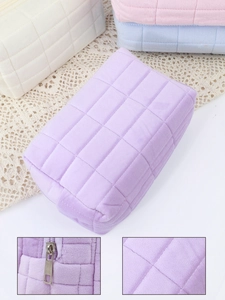 Detail showing high-quality quilted velvet texture and durable metal zipper on cosmetics bag