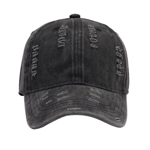 Vintage washed black distressed baseball cap with ripped holes and retro street style