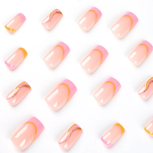 French tip press-on nails with pink orange waves and gold glitter accents