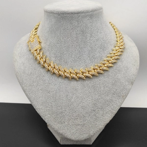 Close-up of a 16mm gold-toned Cuban link necklace with thorns and pave-set rhinestones