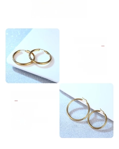 Detailed macro of mirror polished gold-plated hollow hoop earrings in stainless steel