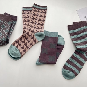 Detailed knit texture of autumn wool socks with plaid and houndstooth patterns