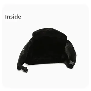 Inside view of black trapper hat featuring thick thermal faux fur lining and buckle strap