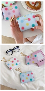 Detail of colorful polka dot wallets with heart pendant and cross-grain PU leather texture