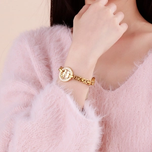 Gold stainless steel thick chain bracelet with hollow gender symbol pendant on model