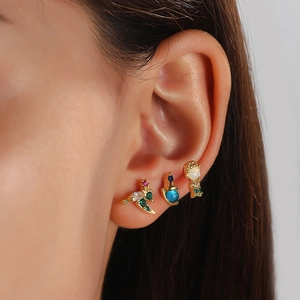Gold animal earrings set with colorful micro-pave zircons worn by model