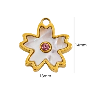 Macro detail of 14k gold plated white shell flower pendant measuring 14mm by 13mm