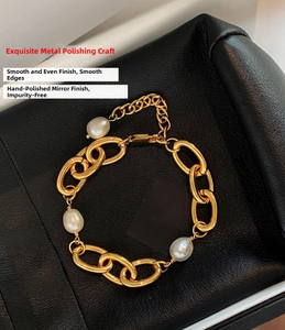 Detail of 18k gold plated chain bracelet with three freshwater pearls on black leather