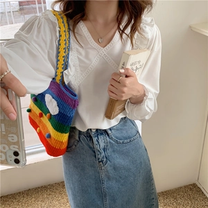 Rainbow crochet knitted shoulder bag styled with a white lace top and denim skirt