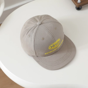 Detail of grey flat brim cap featuring 3D embroidered logo and breathable eyelets