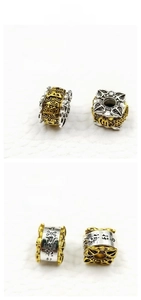 Macro detail of silver and gold prayer beads with 11mm diameter and 3mm hole size