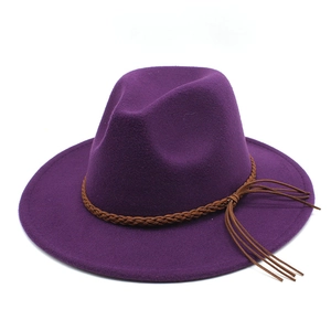 Detail of purple wool felt fedora featuring dark brown braided band and tassel decor