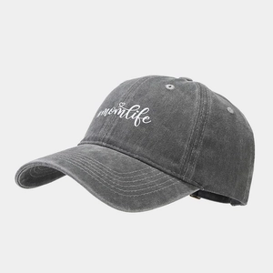 Macro detail of white #momlife embroidery on vintage charcoal grey washed baseball cap