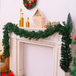 Close-up of 2.7m dense green Christmas garland on a white fireplace mantel