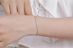 Close-up of minimalist S925 sterling silver tennis bracelet with 2mm moissanite stones