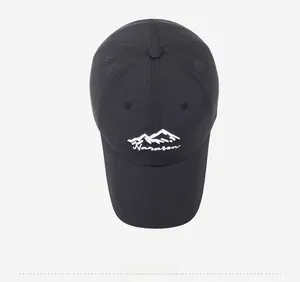 Top view of a black quick-dry baseball cap with white mountain embroidery and laser-cut vents