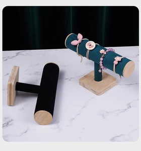 Macro detail of T-bar jewelry stands with wood bases and velvet watch display pillows