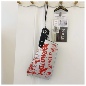 Detailed view of silver cleaver handbag with red blood prints for Halloween party