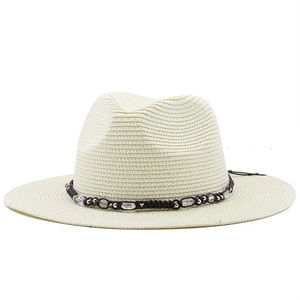 Close-up of finely woven cream straw Fedora hat with beaded leather trim and texture