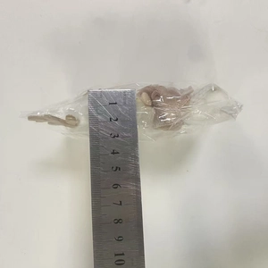 Pink plush reindeer angel doll measurement showing approximately 5cm length with a steel ruler
