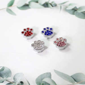Macro shot of 8mm glitter rhinestone dog paw charms in four colors for DIY wristbands