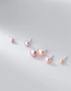 Detail of freshwater pearl studs showing 3-8mm size gradient and natural luster