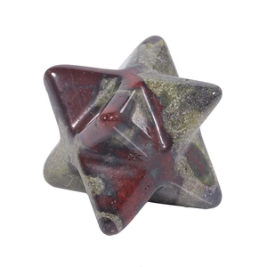 Macro shot of green and red speckled natural stone Merkaba star with polished finish