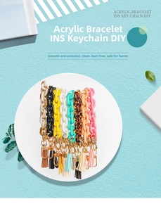 Detailed close-up of colorful acrylic chain keychains with tassels and golden hardware