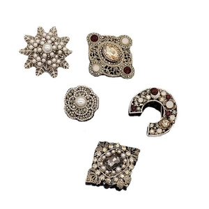 Vintage baroque style flower brooches with pearls and rhinestones on white background
