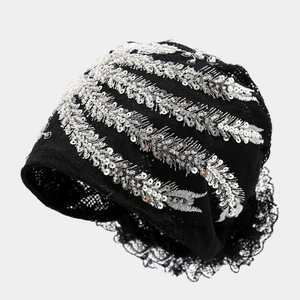 Detailed view of black mesh headscarf featuring silver sequins and lace trim edges