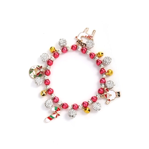 Close-up of Christmas charm bracelet with Santa, reindeer, and colorful holiday bells