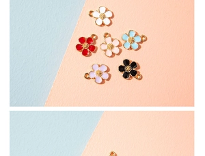 Detail of colorful floral alloy charms with enamel finish and metal edging for DIY jewelry