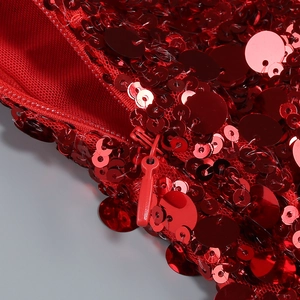 Détail de la fermeture éclair invisible et des paillettes rouges sur la robe licou de Noël