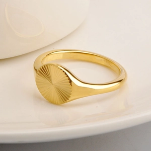 Detailed close-up of 18K gold plated sunburst signet ring with a polished vintage finish