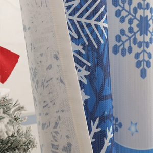 Detail of floral blackout curtain fabric with blue snowflake and star patterns