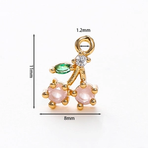 Macro view of cherry-shaped gold plated pendant with pink stones and 11mm size detail