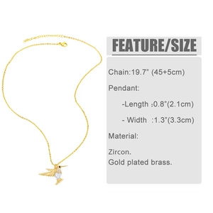 Macro shot of gold hummingbird necklace with heart zircon inlay and exact dimensions