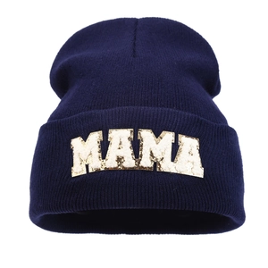 Navy blue knitted beanie for women featuring MAMA embroidery and a minimalist winter style