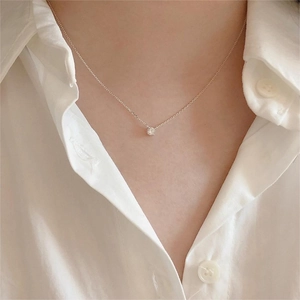 Elegant 925 sterling silver necklace with four-prong cubic zirconia worn by model