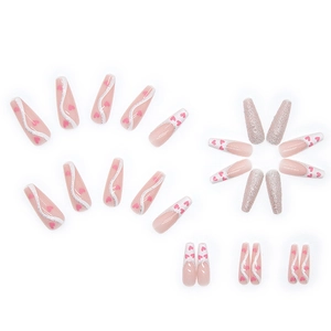 Pink heart French press-on nails set in long coffin shape with silver glitter details