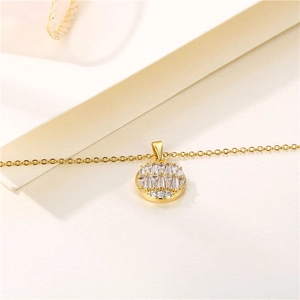 Elegant gold round pendant necklace with micro-pave cubic zirconia on a soft beige background